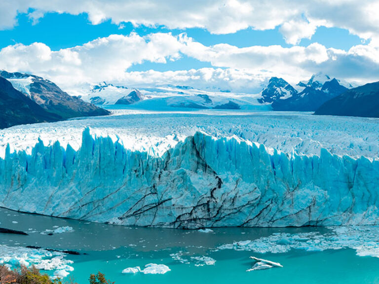 The awe-inspiring Perito Moreno Glacier spans three miles in width and over 250 feet high, attracting visitors worldwide. Tours offer an up-close experience, and adventure seekers can walk on its surface with crampons.
