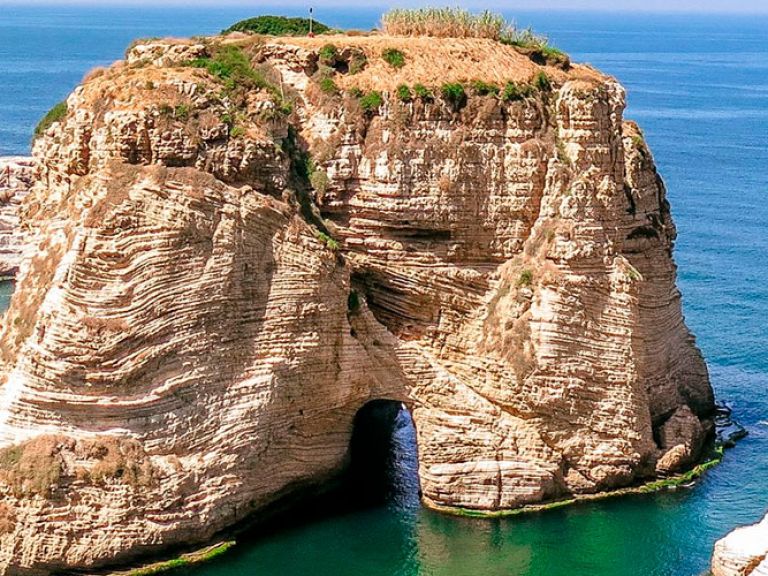Pigeon Rocks, off Raouche coast in Beirut, Lebanon, captivates with stunning views. Twin rock formations, around 60 meters high, rise from the Mediterranean Sea. They're famed for their beauty and the pigeons that inhabit their crevices.