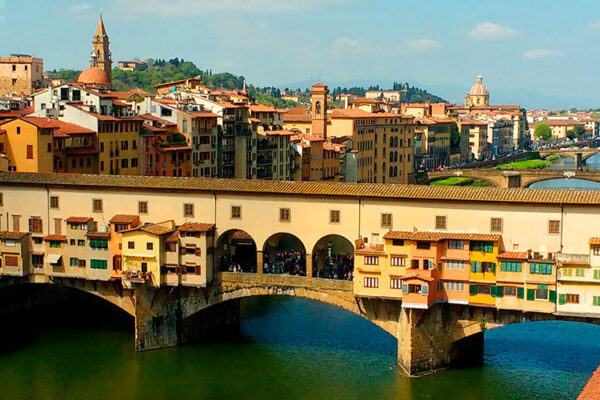 Ponte Vecchio (Old Bridge) is a medieval arched bridge over the River Arno in Florence, Italy, famous for having a number of shops (mostly gold and jewelers) built along it. The bridge is one of the most famous tourist attractions in Florence. It spans the Arno at its narrowest point where it is believed that a ford was once located.