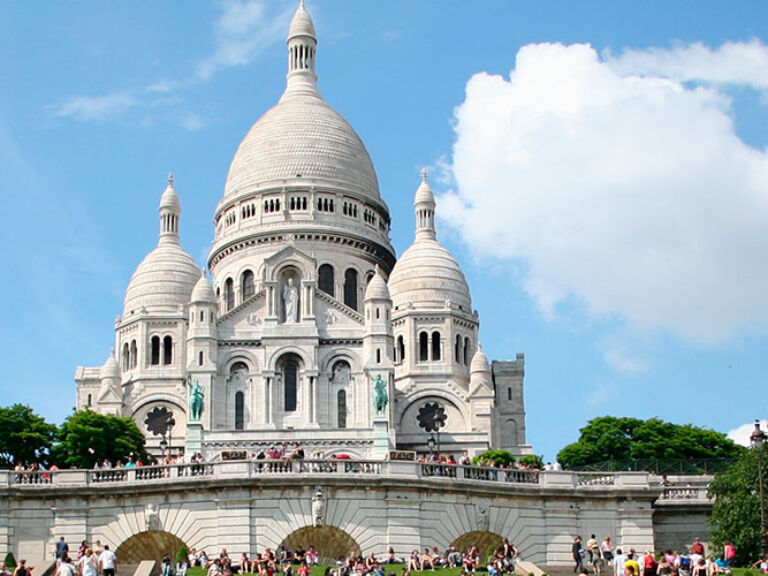 The Sacré-Coeur, consecrated in 1919 and perched atop Butte Montmartre, offers stunning Paris views and, as an iconic monument, is a must-visit part of France's rich history.