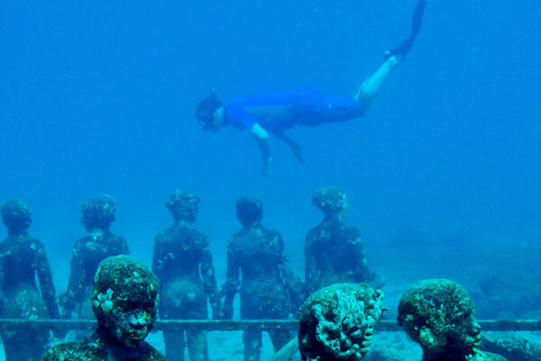 Cancun's Underwater Museum, a top attraction, showcases 500+ locally crafted, life-size statues across two galleries. Depicting Mexican history and culture, visitors can explore these underwater scenes through snorkeling or scuba diving, often amidst diverse marine life.