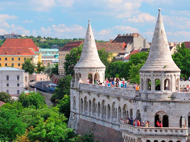 Experience breathtaking views of Budapest and the Danube River from Fisherman's Bastion, a stunning terrace in the Buda Castle District. Admire its decorative fortification, seven towers representing Hungary's tribes, and picturesque charm, making it a favorite tourist attraction and wedding photography spot.