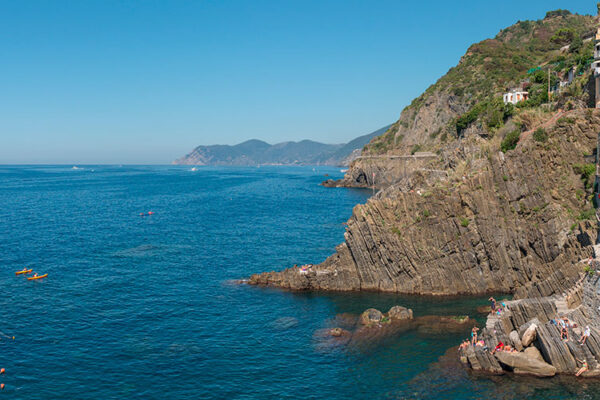 Riomaggiore, the southernmost village of Cinque Terre, is a short train ride from La Spezia. Its charming main piazza is linked to the train station through a characteristic tunnel. The picturesque village features multicolored houses along the harbor.