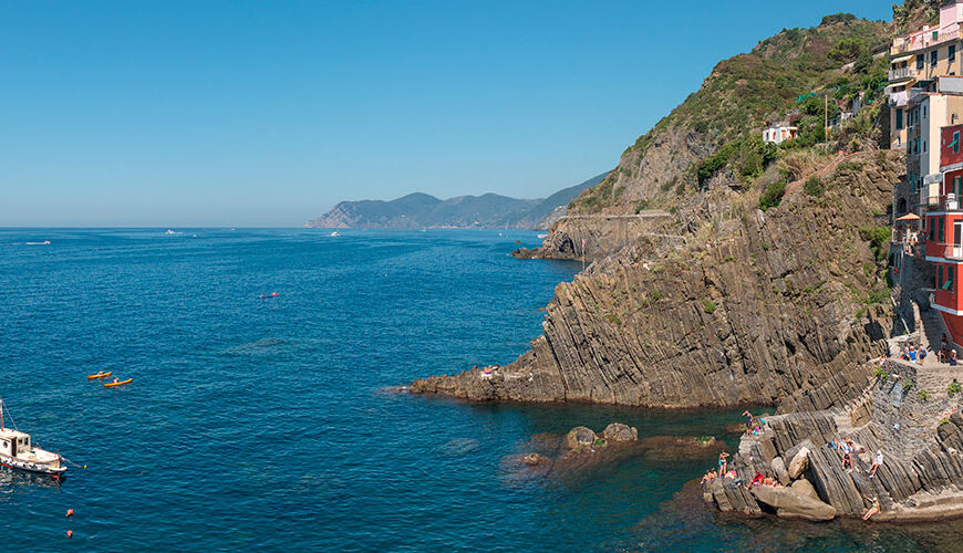 Riomaggiore, the southernmost village of Cinque Terre, is a short train ride from La Spezia. Its charming main piazza is linked to the train station through a characteristic tunnel. The picturesque village features multicolored houses along the harbor.