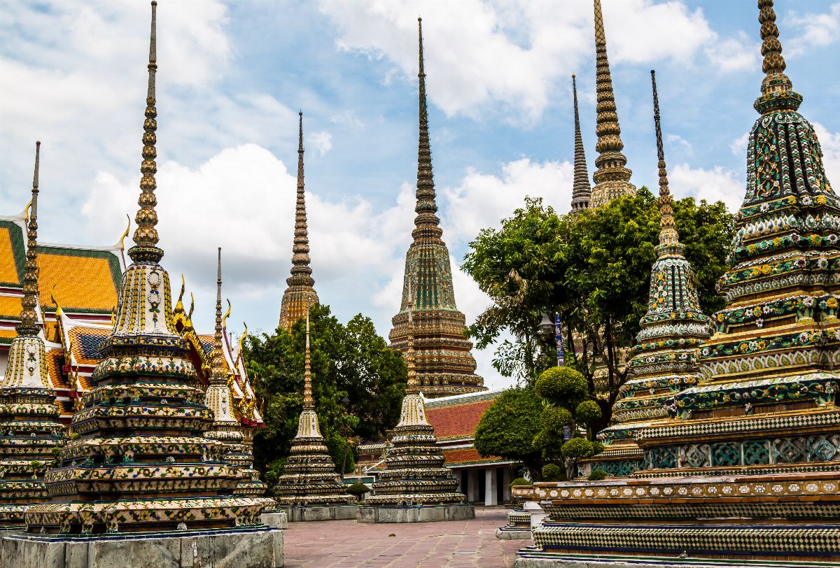Wat Pho And Wat Arun Walking Tour with Professional Guide. Delve into the spiritual core of Bangkok by starting your journey at Wat Pho, home to the impressive 46-meter long reclining Buddha statue. As you wander through the temple grounds, let yourself be immersed in the rich history, intricate architecture, and centuries-old religious practices that this temple offers. No trip to Bangkok is complete without witnessing this giant depiction of the Buddha's enlightenment.