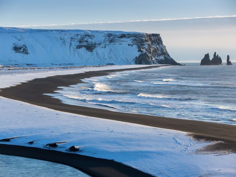 South Coast Classic (Guided In 10 Languages): Drive along the southwestern stretch of the ring road leading from Reykjavik along volcanoes, waterfalls, and glaciers to the black sand beach and Iceland's southernmost town, Vík. The tour starts with a drive through the Hellisheiði mountain pass bringing you through moss-covered lava fields and past geothermal springs down to farmland along the coastline.