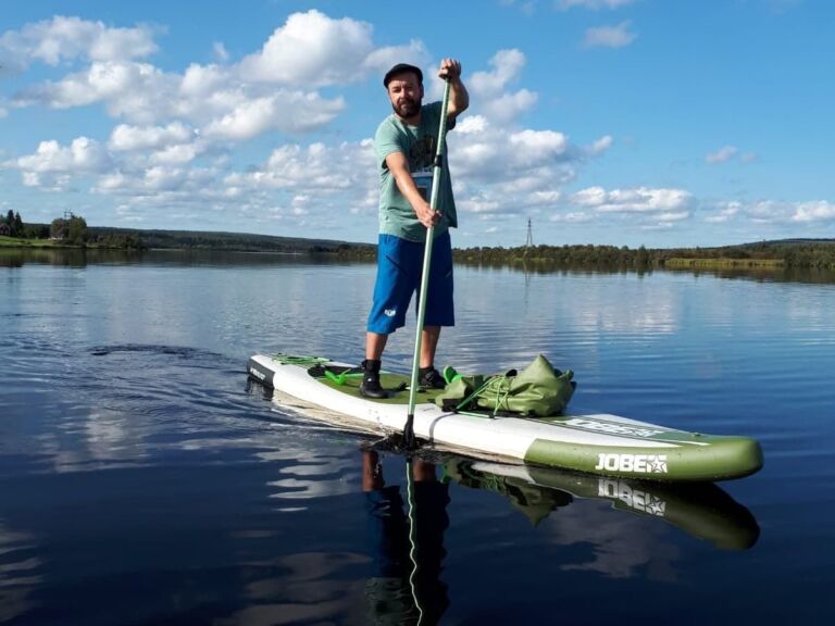 Arctic summer SUP boarding on a lake and river.