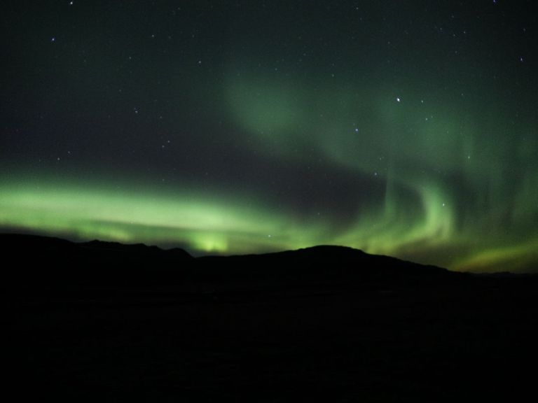 The Northern Lights, also known as the aurora borealis, is a natural light display in the Earth's sky, predominantly seen in the high-latitude regions (around the Arctic and Antarctic). These lights are caused by the collision of solar particles with atoms in the Earth's atmosphere, which results in the emission of light in different colors, primarily green, yellow, pink, purple, and red. The intensity and color of the lights can vary depending on the level of solar activity, and they are most visible during the dark winter months.