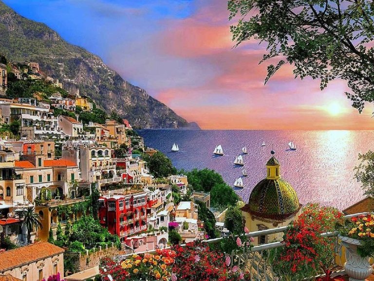 Positano & Amalfi - The tortuous street slips over deep gorges and runs down toward the beach and climbs up again along a...