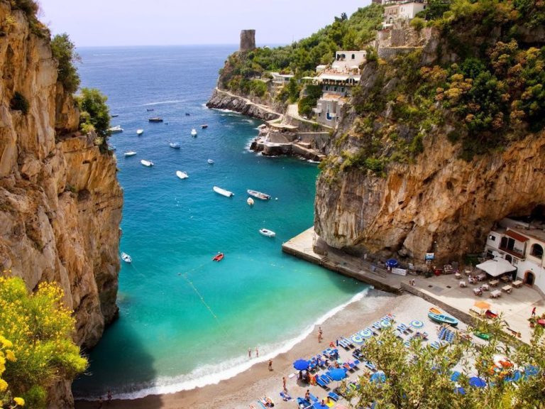 Positano & Amalfi - The tortuous street slips over deep gorges and runs down toward the beach and climbs up again along a...