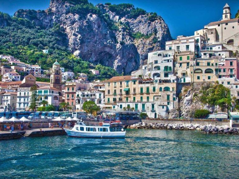 Positano & Amalfi - The tortuous street slips over deep gorges and runs down toward the beach and climbs up again along a...