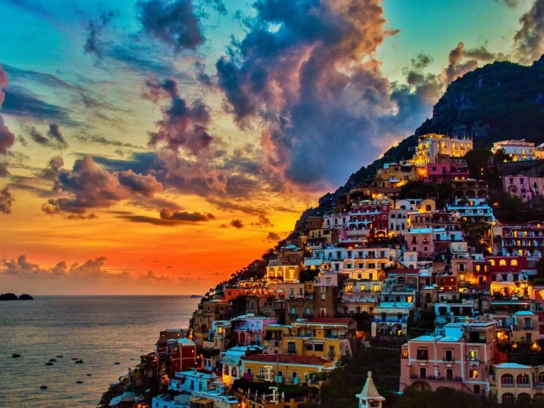 Positano & Amalfi - The tortuous street slips over deep gorges and runs down toward the beach and climbs up again along a...
