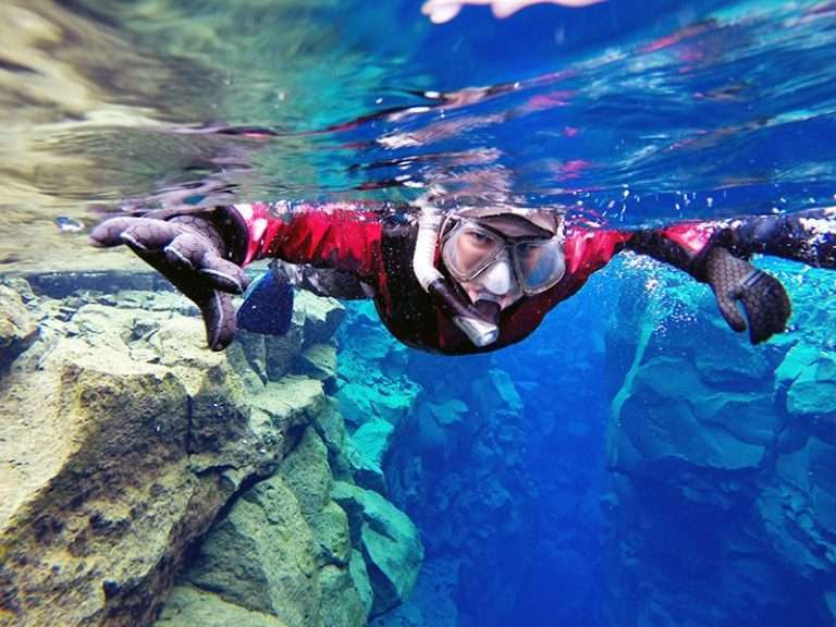 Silfra Snorkeling & Leidarendi Lava Tunnel | Free Underwater photos  - Combining snorkeling and caving gives you the ultra experience of Icelandic nature. You will explore the hidden world of the lava fields by foot by caving in the Blue Mountain area and visit the UNESCO World Heritage site, Þingvellir national park and snorkel the freshwater fissure Silfra, one of the best diving site in the world.