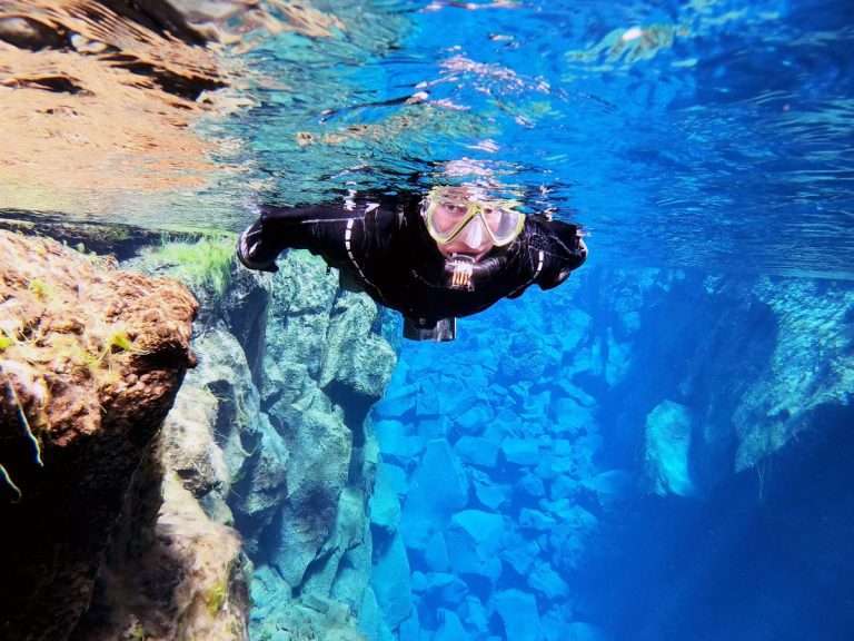 Silfra Snorkeling & Leidarendi Lava Tunnel | Free Underwater photos  - Combining snorkeling and caving gives you the ultra experience of Icelandic nature. You will explore the hidden world of the lava fields by foot by caving in the Blue Mountain area and visit the UNESCO World Heritage site, Þingvellir national park and snorkel the freshwater fissure Silfra, one of the best diving site in the world.