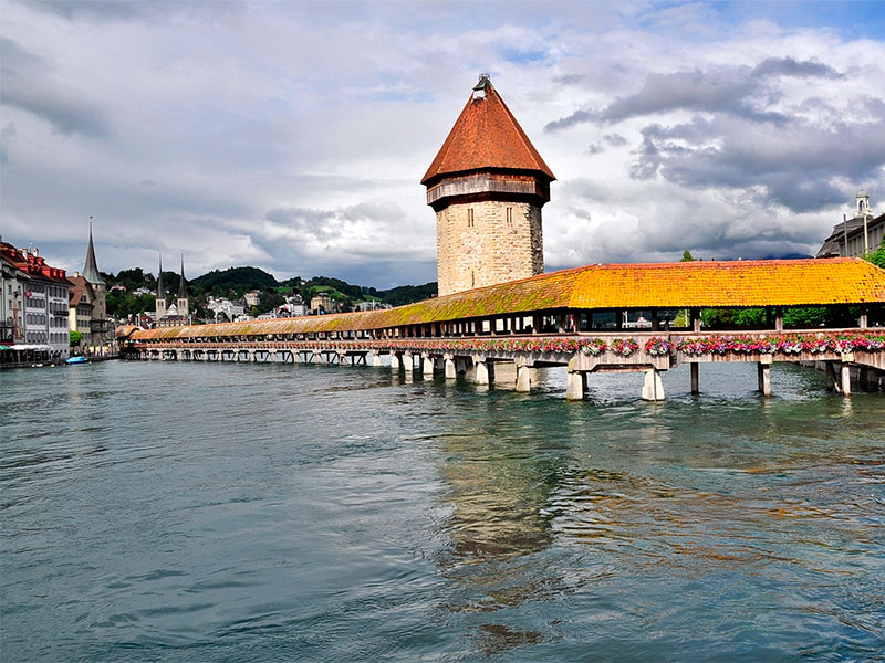 Nestled in the heart of Lucerne, the Kapellbrücke (Chapel Bridge) stands as a symbol of Swiss architecture and culture. This unique wooden bridge, the oldest covered bridge in Europe, spans the picturesque Reuss River and offers breathtaking views of Lake Lucerne.