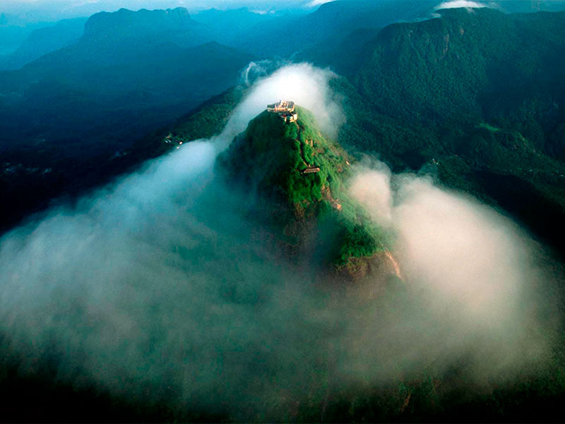Adam's Peak, also known as Sri Pada, is a revered mountain in Sri Lanka's Central Highlands. Famous for the sacred footprint at its summit, the peak attracts pilgrims and adventurers alike. Offering a challenging hike and breathtaking panoramic views, it's a spiritually enriching and visually stunning experience.