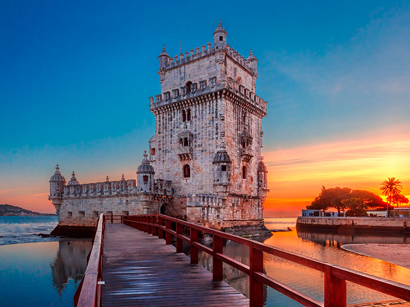 Lisbon Travel Guide: One cannot visit Lisbon without paying homage to the iconic Belém Tower. Situated at the mouth of the Tagus River, this UNESCO World Heritage site was initially built as a defensive fortress and later transformed into a gateway for explorers. It serves as a testament to Portugal's Age of Exploration and is a must-visit for anyone interested in maritime history.