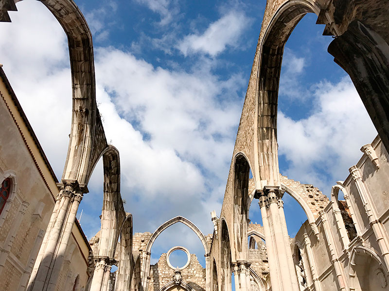 Lisbon Travel Guide: Another striking landmark is the Carmo Convent, a roofless Gothic church that stands as a silent witness to the 1755 earthquake's destruction. Visiting the ruins offers an eerie yet fascinating journey into Lisbon's resilience and recovery after one of its most tragic events.