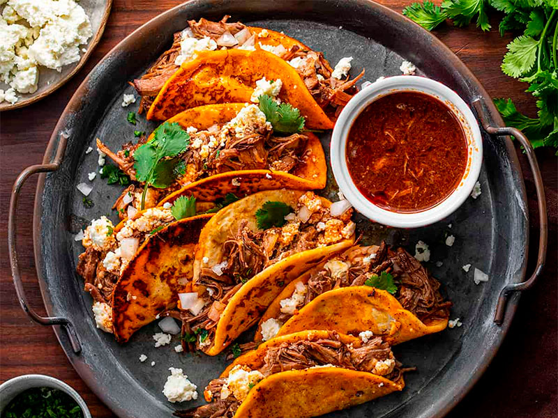 Baja California Sur Travel Guide: Experience the rich flavors of Mexican tradition with dishes like tamales, made from masa and stuffed with meats or cheese, and enchiladas, which feature tortillas filled with various ingredients and smothered in sauce.